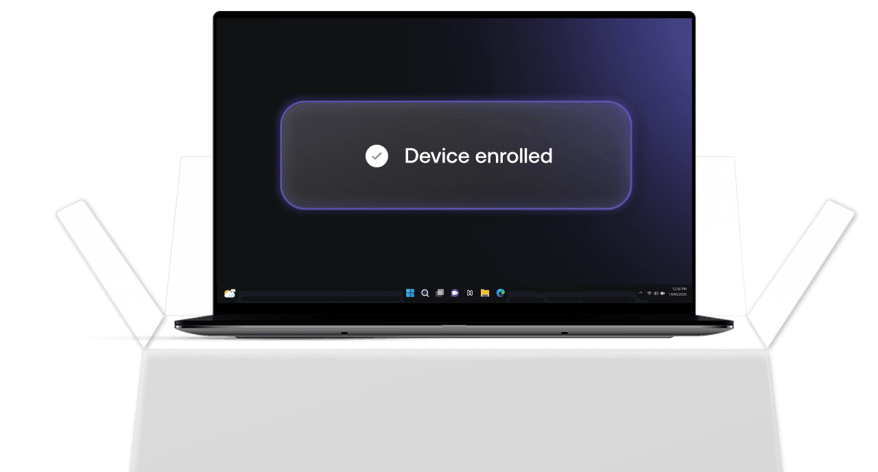 A Mac laptop screen showing a glowing “Device enrolled” confirmation banner, indicating successful macOS enrollment.
